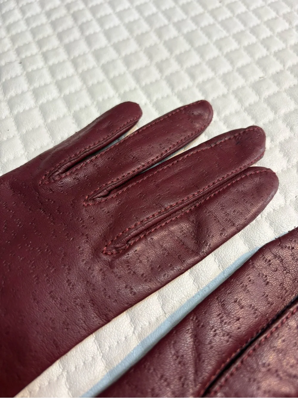 maroon leather gloves feature a distinctive textured perforated pattern 6.5